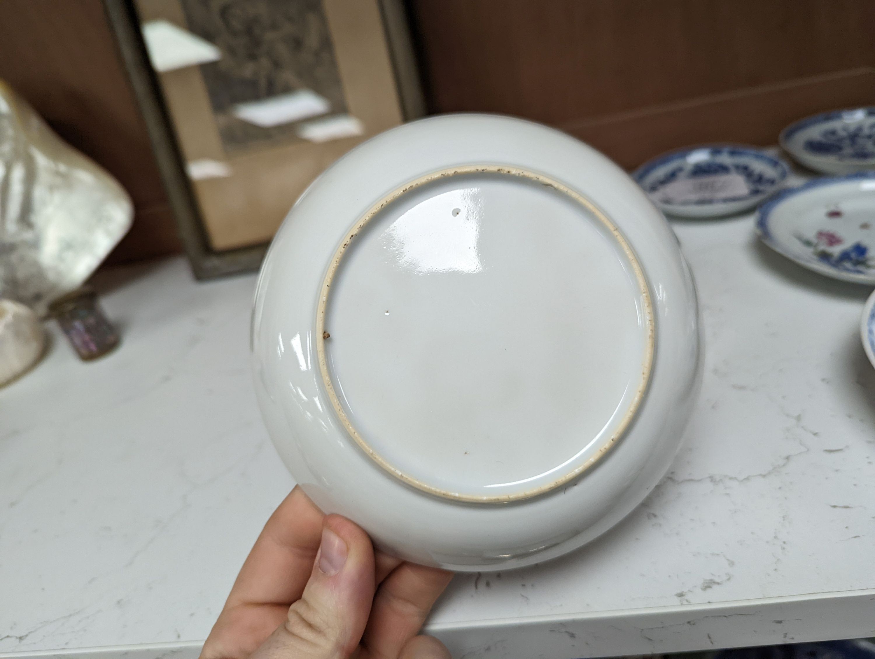 Seven 18th century Chinese saucer dishes, largest 14 cms diameter.